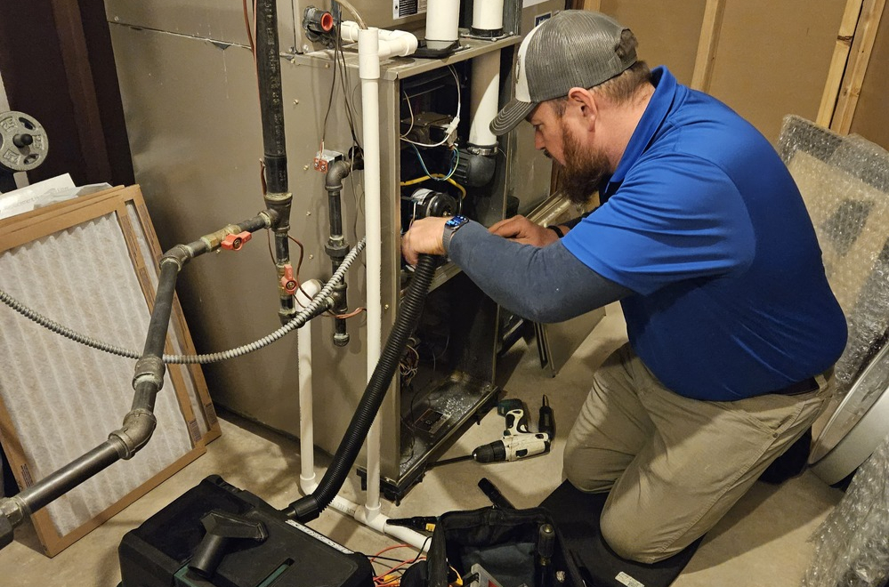 Cost U Less HVAC technician repairing residential heating system